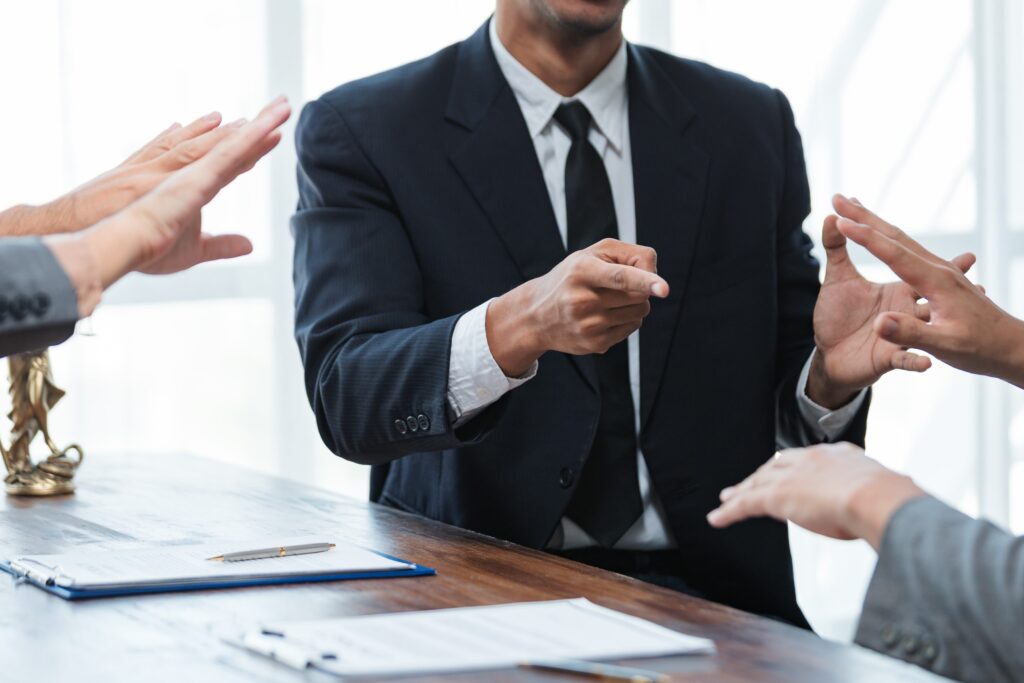 Lawyers having meeting and discussing contract terms in office, false accusations