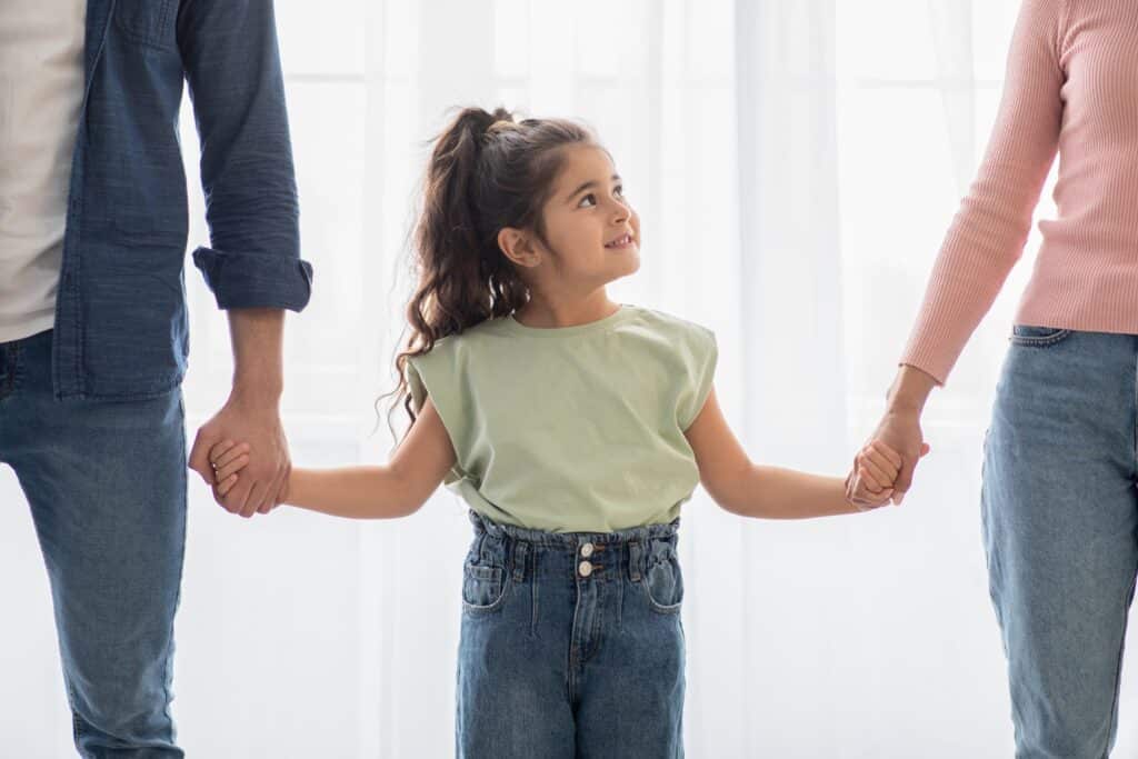 Adorable Cute Little Arab Girl Holding Hands With Parents At Home, Closeup child custody lawyer caloundra