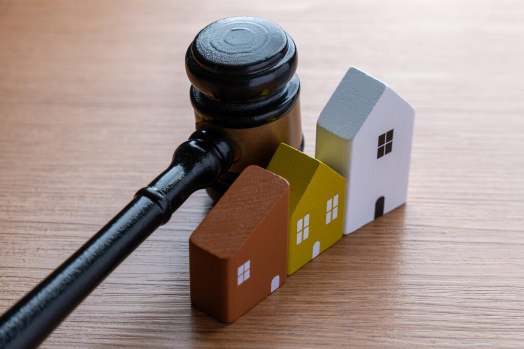 Gavel and Miniature Wooden Houses on Desk