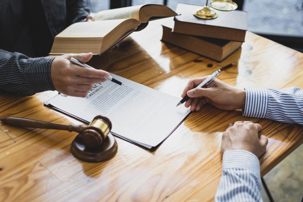 Lawyers Reviewing Contract Agreement on Wooden Table
