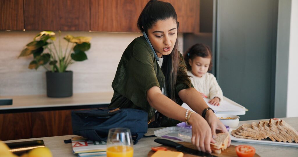 Daughter, lunch and phone call with mother packing in kitchen for multitasking or preparation. Busy, getting ready and food with single parent making school snack for girl child in apartment