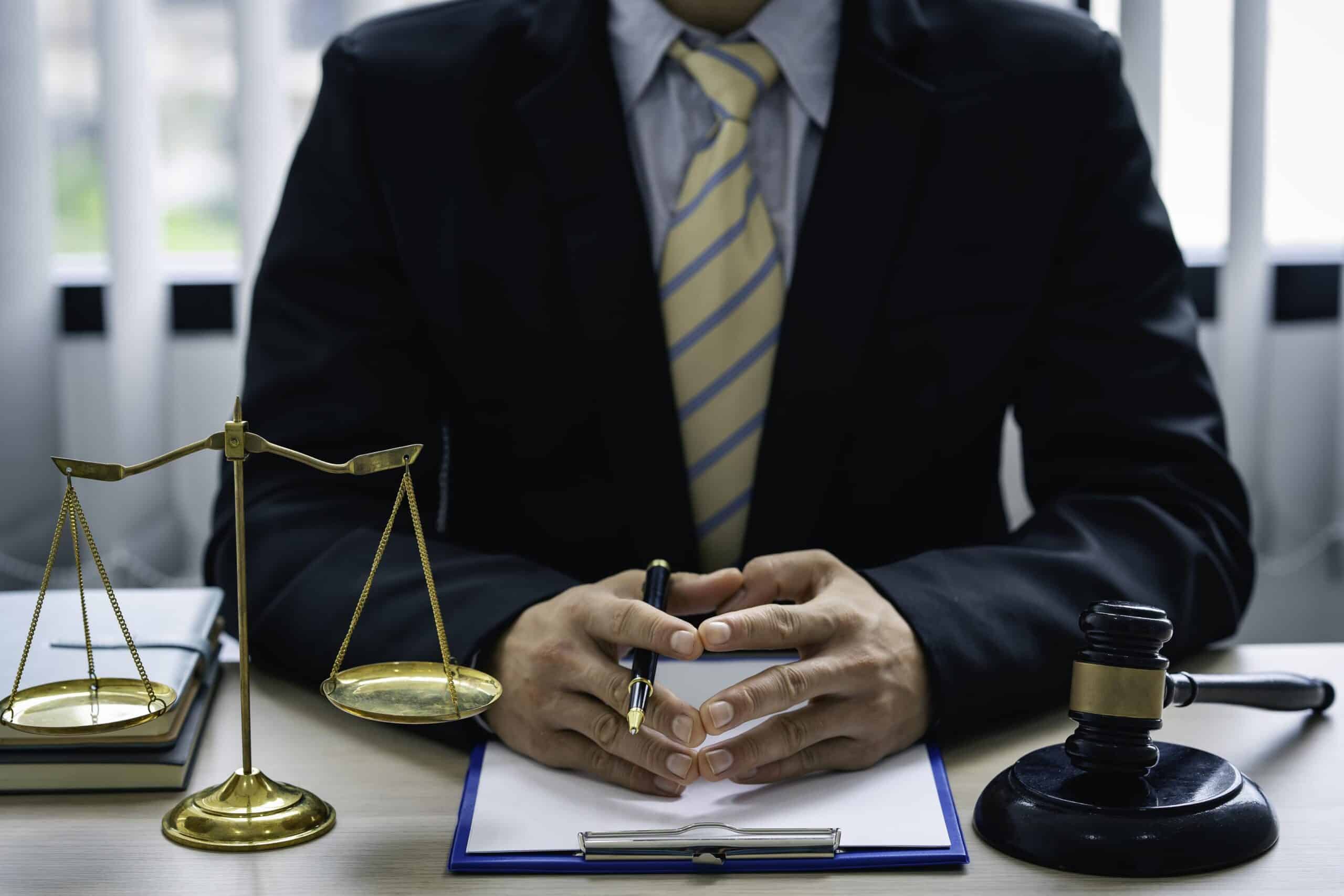 Lawyer at Desk with Scales of Justice