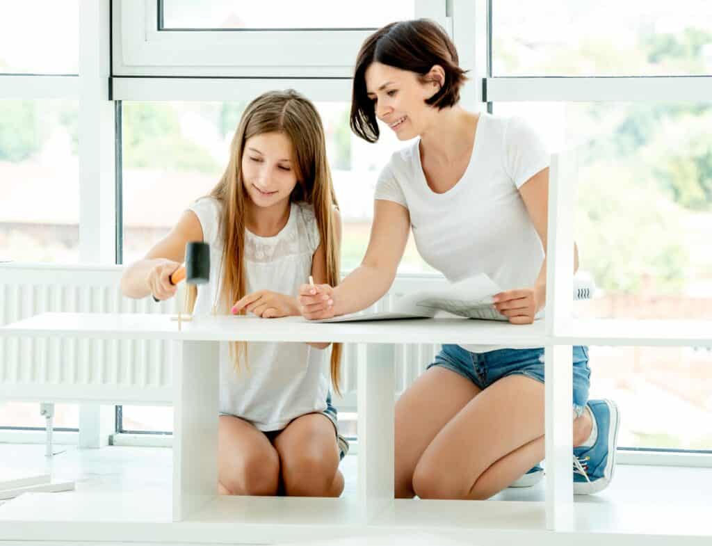 Girl and Woman Assembling Furniture Indoors